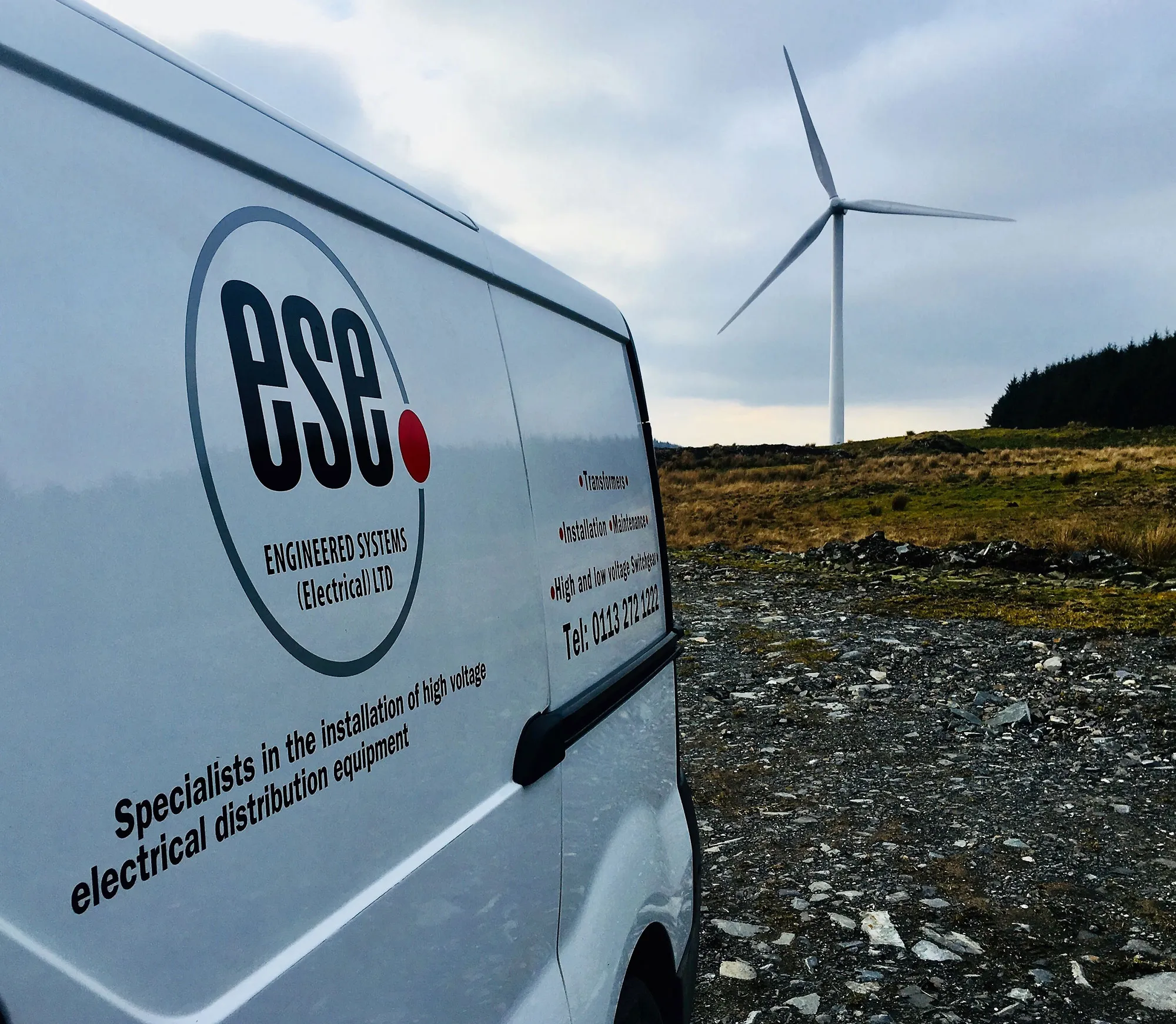 ESE van with a wind turbine in the background 