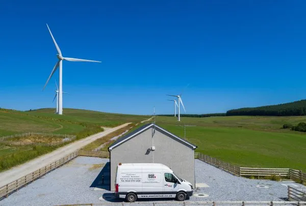 ESE Van with wind turbines in the background 